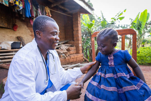 Friendly young Pediatrician visiting a sick baby girl in the village.